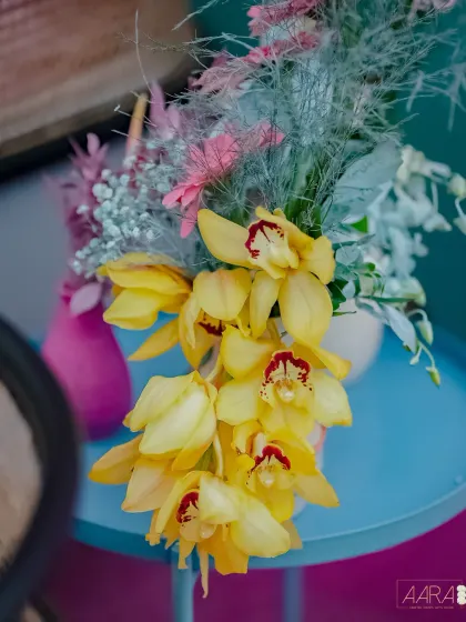 A close-up of a floral detail from our 'Mehendi Fiesta'. The vibrant yellow orchids and colorful chrysanthemums perfectly capture the event's playful and energetic theme.