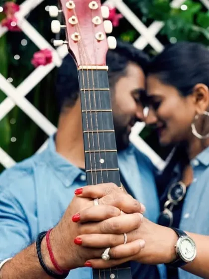 A creative and intimate pre-wedding photo, using a guitar to frame the couple's connection.