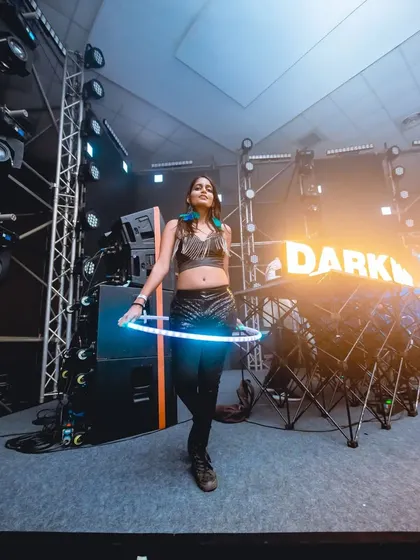 A moment of calm on the big stage at the Darkroom festival. The glowing LED hoop creates a striking silhouette against the complex stage lighting.