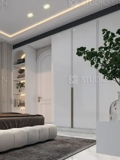 This angle shows the full wall of handle-less wardrobes, which blend into the background and enhance the minimalist aesthetic.