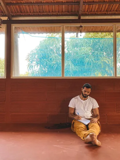 A student finds a quiet corner to journal. We encourage self-reflection as a key practice to integrate the teachings, process emotions, and track your personal growth throughout the training.