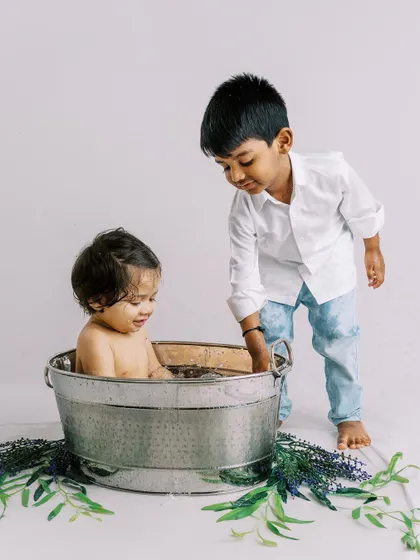 Big brother helping his little brother during the bathtub part of the first birthday shoot. These unscripted moments of sibling connection are pure gold.