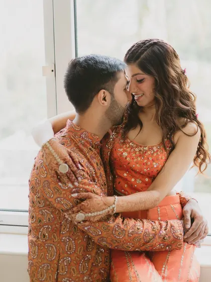 An intimate couple's portrait from the Mehendi. The soft, natural light highlights her glowing skin and the subtle makeup details.