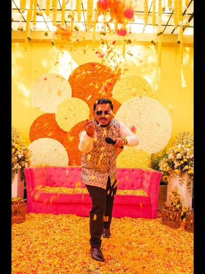 Throwing flower petals, fully immersed in the fun of a Haldi.
