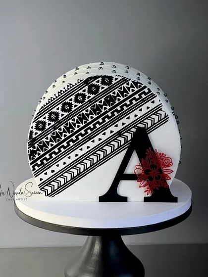 A bold, black acrylic initial "A" used as a cake charm on a top-forward cake. This is a great example of how our custom pieces can be used for modern cake designs.