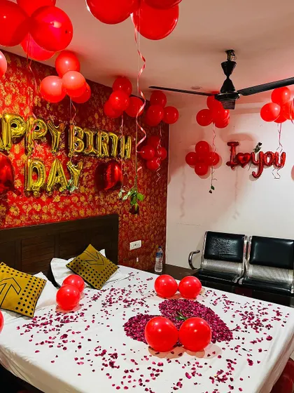 The full room view, including "I love you" foil balloons and flower-shaped balloon clusters on the ceiling, shows how we utilize the entire space for a complete transformation.