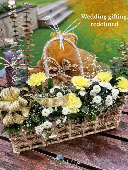 I believe in redefining wedding gifting, turning it into an art form that tells your unique story. This hamper, overflowing with fresh flowers and thoughtfully chosen gifts, is a perfect example of how I blend abundance with elegance, creating a moment that feels both grand and deeply personal.