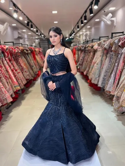 A stunning navy blue fish-cut lehenga with intricate beadwork. This is one of my most popular rental styles for cocktail parties and receptions, perfect for making a statement.