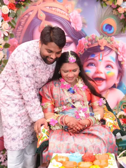 A candid moment of affection as the husband-to-be leans in towards his wife during their baby shower celebration.