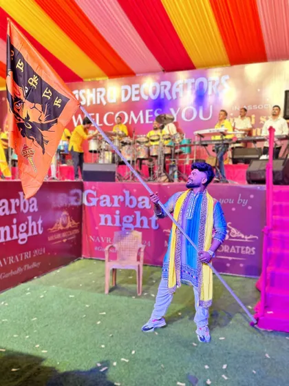 Holding the flag, ready to kick off the Garba night.