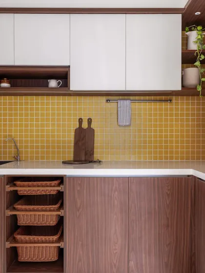 Another view of the 'Living Life in Colour' kitchen, showcasing the open wicker baskets and clean lines of the cabinetry.