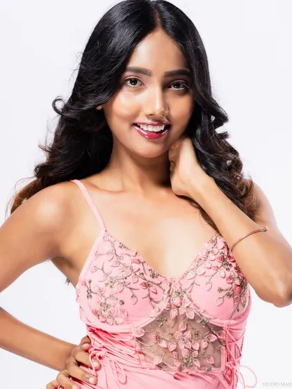 A smiling portrait of the model in the pink dress.