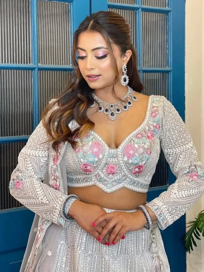 A modern, fashion-forward look featuring a pearl-encrusted gown. The simple diamond drop earrings are the perfect accessory for this statement outfit.