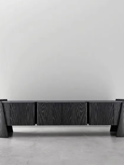 Details that define distinction. This sideboard in a dark, open-grain wood finish features a powerful, sculptural form with curved end supports.