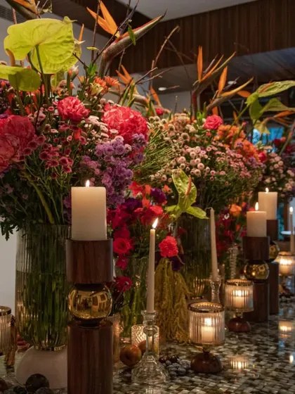The full tablescape inspired by our 'Made in Heaven' designs, created for a 30th birthday party. The mix of tropical flowers, jewel tones, and warm candlelight creates a vibrant and sophisticated atmosphere.