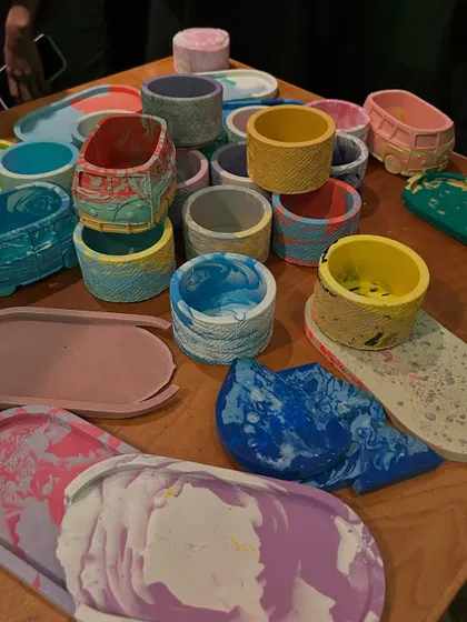 A collection of finished Jesmonite trinket trays and planters. The variety of colors and patterns is stunning.