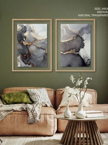 This set of two fluid ink abstract paintings combines grey and golden tones for a sophisticated, earthy look. The natural transparent frames provide a minimalist finish, allowing the artwork's texture to stand out.