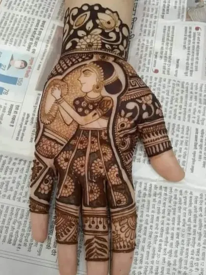 A single-hand portrait of a bride holding a diya. This type of artistic figure work is perfect for one hand while the other can have a matching traditional pattern.
