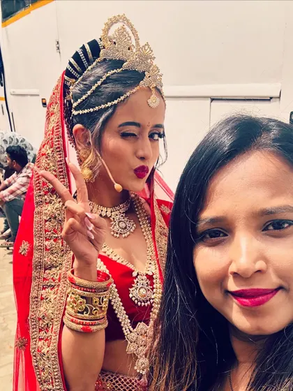 A fun behind-the-scenes selfie with an actress in a red bridal lehenga for a shoot.