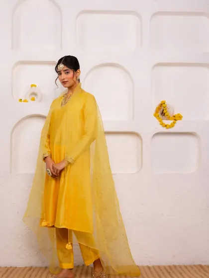 A festive look I styled for A.Projekt, featuring a vibrant yellow salwar suit. The creative direction focused on a clean, minimalist backdrop with pops of yellow flowers to complement the outfit.