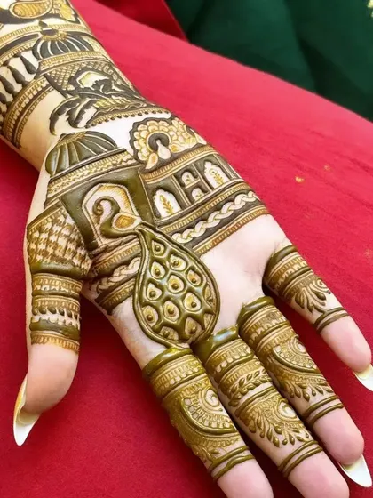 A close-up of a hand with a 3D-style peacock design. The shading technique makes the peacock motif stand out from the background patterns.