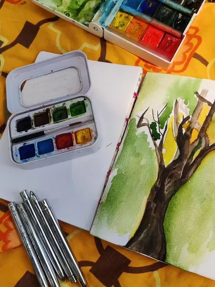 A flat lay of my art supplies during an outdoor painting session. I often bring different materials for everyone to try, so you can experiment and find what you love.