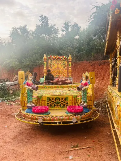 A wide view of a procession chariot, showing the arrangement of deities and decorative elements on the platform.