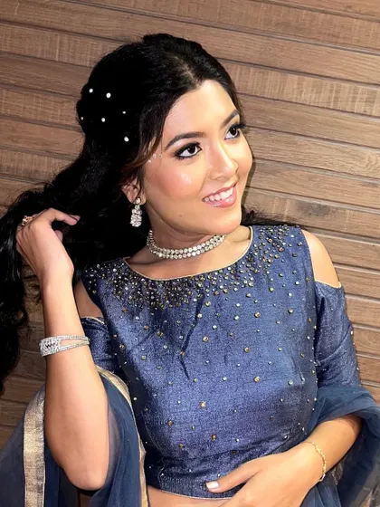 A happy, candid shot that shows the makeup and hair in a more natural, dynamic pose.