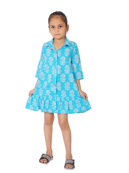 A final, edited shot of a girl in a blue printed dress, ready for an e-commerce catalogue.