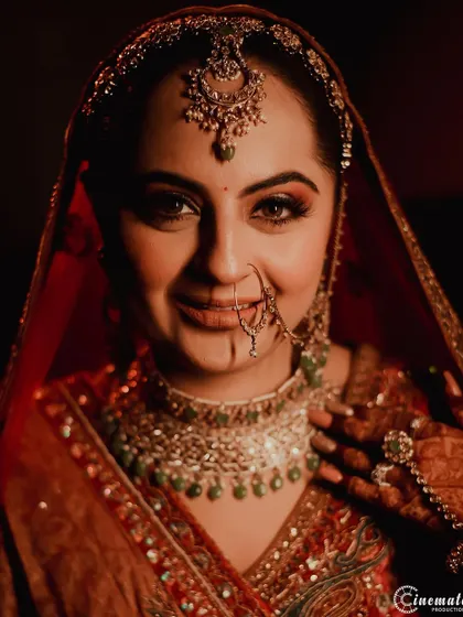 A beautiful close-up portrait of a Sikh bride, capturing her warm smile and the stunning details of her traditional jewelry.