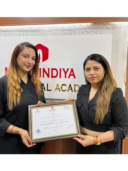 Another dedicated student receives her certificate, marking her entry into the professional beauty industry.