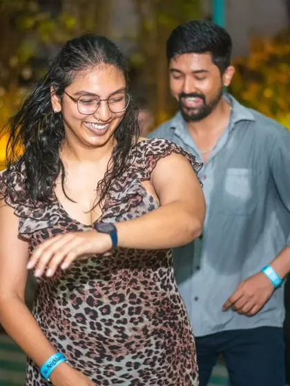 A happy dancer checking her watch, but still lost in the music. Time flies when you're having fun.