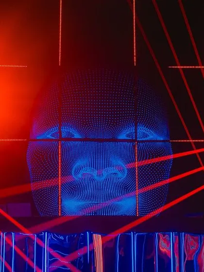 We created this immersive photo installation using a grid of red lasers and a projected digital face. It provided a futuristic and interactive experience for guests.
