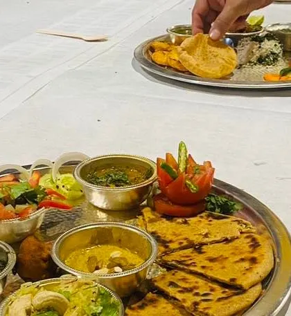 A beautifully plated traditional Indian thali prepared by one of the teams during the cooking competition. The activity challenges participants' creativity and presentation skills, not just their cooking.