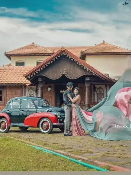 This couple poses with a vintage car, with the multi-colored trail gown adding a whimsical and colorful touch to the classic, rustic setting.