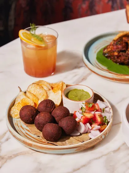 Our Mutton Goli Kababs, served with potato chips and avocado dip. These flavourful meatballs are a perfect snack to share, or not.