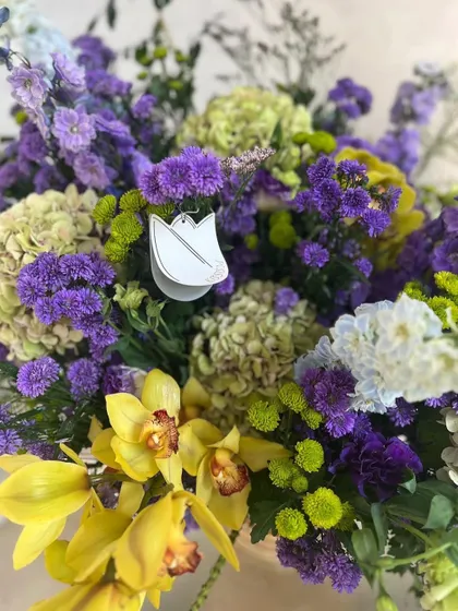 This arrangement screams opulence and whispers romance. The combination of lime green hydrangeas and violet orchids and lisianthus is showstopping and lush.