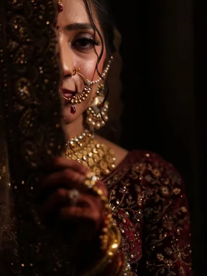 A candid moment capturing the bride's intricate nath and smokey eye makeup. I love creating looks that feel both traditional and modern.