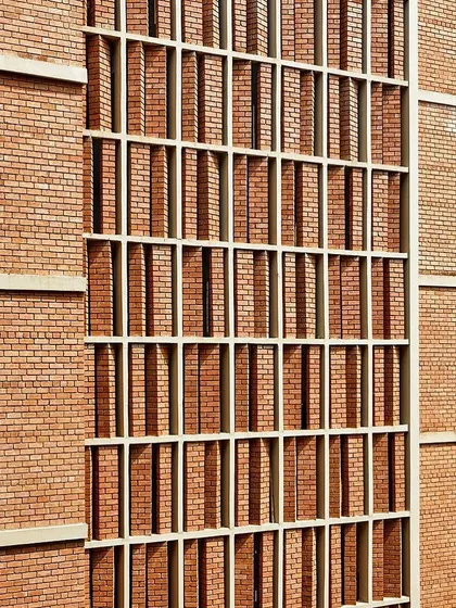 The compressed earth block (CEB) facade at the Symbiosis University Hospital and Research Center in Pune. This sustainable material choice not only reduces environmental impact but also gives the building a warm, earthy aesthetic that connects it to its site.