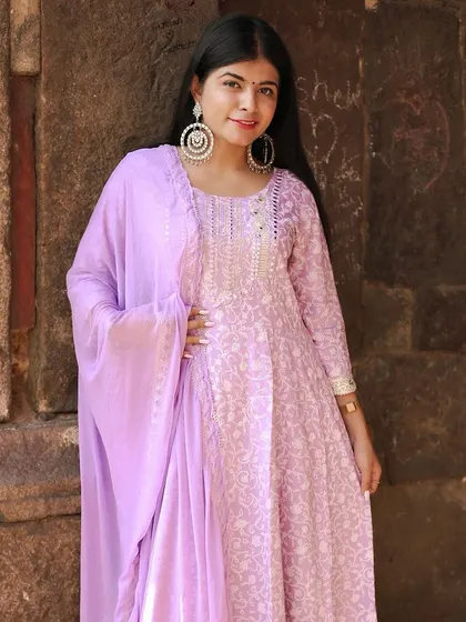 A three-quarter shot that showcases the flow of the anarkali suit and the matching dupatta.