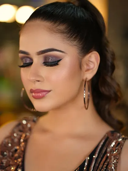 A close-up of the glittery smokey eye. The purple and black glitter adds incredible dimension and sparkle, perfect for an evening event.