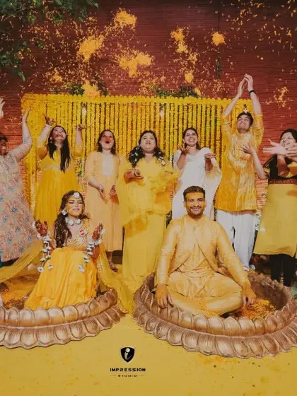 The whole family joins in for a flower shower during the Haldi. This shot is all about the collective joy and celebration of the community.