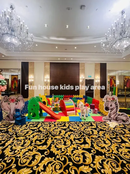 This impressive rainbow setup fills a large ballroom, providing a huge play space with slides, tunnels, and rockers for a big event.