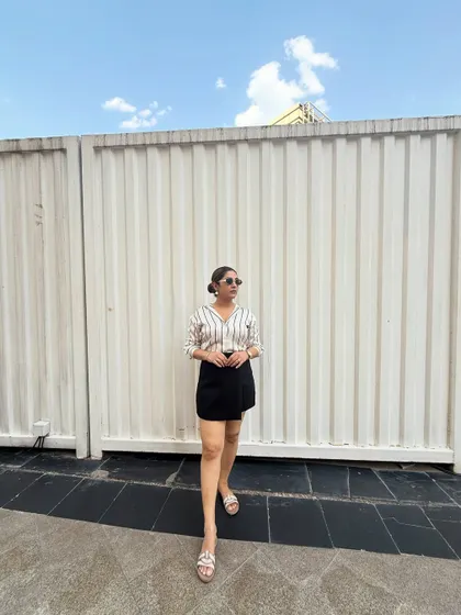A classic look featuring a striped shirt and a black skort. This demonstrates how simple, well-chosen basics can create a chic and put-together outfit for a casual day out. My goal is to make styling easy for you.