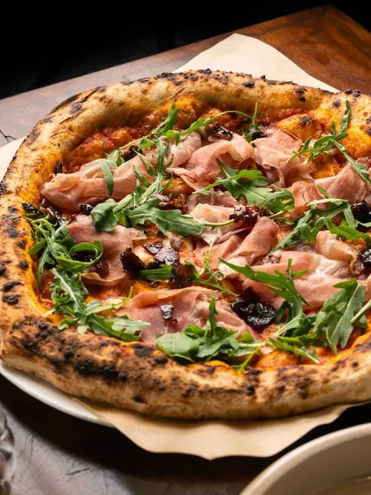 For those who love a balance of sweet and savory, my Prosciutto and Fig pizza is a must-try. Salty prosciutto, sweet figs, and peppery arugula come together on our classic crust for a truly sophisticated flavor experience.