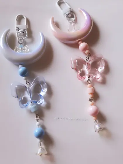 A closer look at my moon and butterfly charms in both blue and pink. The iridescent moon and translucent butterflies create a truly magical and ethereal look.