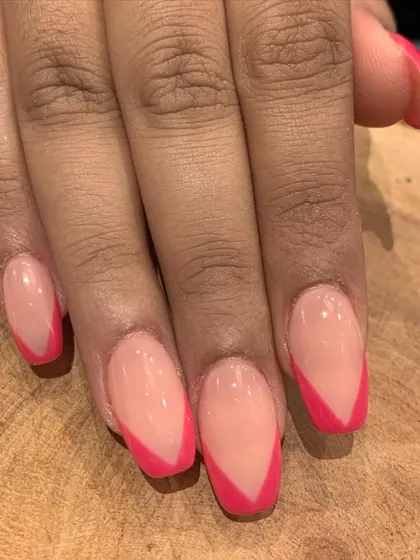 A sharp and modern V-shaped French manicure using a vibrant pink. This is a fun and bold way to update a classic look.
