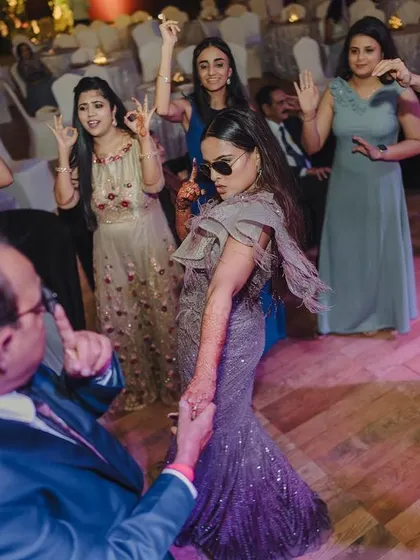 Guests of all ages enjoying the dance floor at a glamorous reception. I create an inclusive and fun atmosphere for everyone.