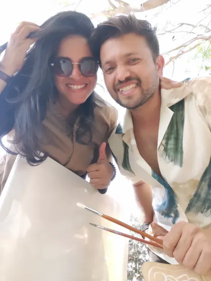 That's us, Varsha and Vivek, ready to paint at a bucket-list wedding. We're so excited to bring our passion for art to your big day.