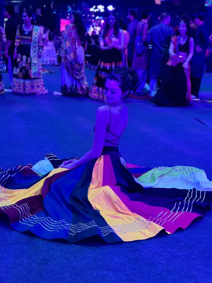 The beauty of a full-circle lehenga spread out on the dance floor. These moments make for fantastic photographs during any Garba or sangeet event.